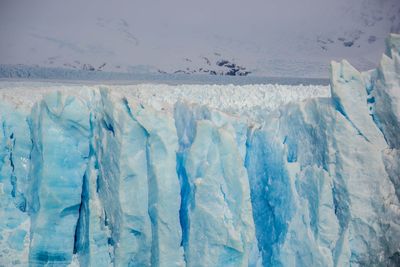 Close-up of ice against sky