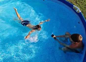 High angle view of people swimming in pool