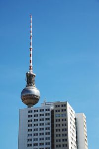 Low angle view of berlin television tower against clear blue sky