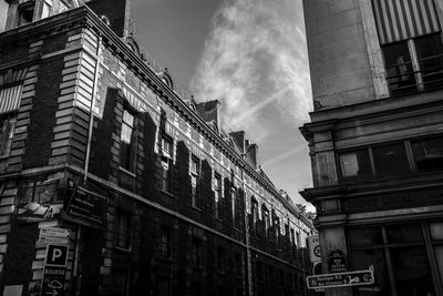 Low angle view of buildings in city against sky