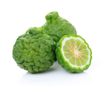 Close-up of green pepper against white background