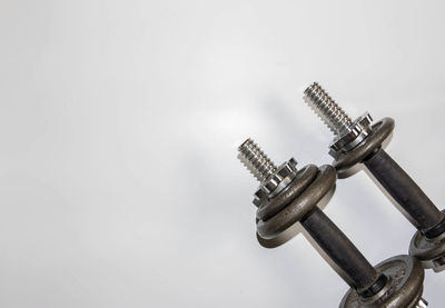 Low angle view of crane against white background