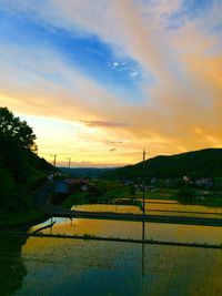 Scenic view of landscape against sky at sunset