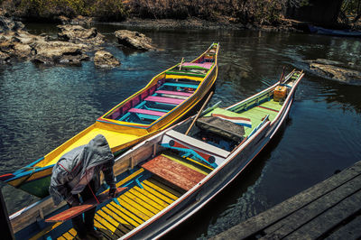 High angle view of man on boat moored at harbor