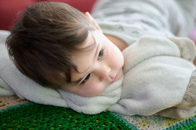 Portrait of a cute young boy watching tv whith his safety blanket