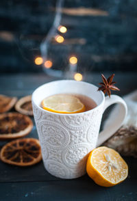 Close-up of christmas tea with lemon on dark background