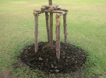 Old wooden pole on field