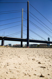 View of suspension bridge against clear blue sky