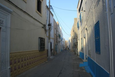 Street amidst buildings against sky