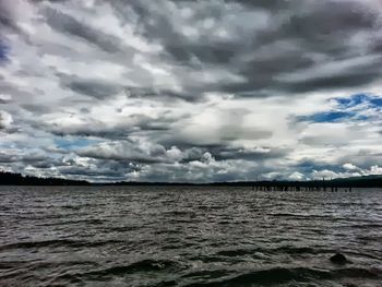 Scenic view of sea against cloudy sky