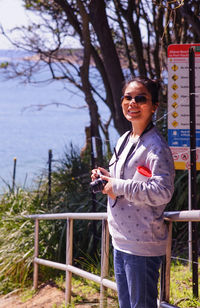 Rear view of woman standing by railing