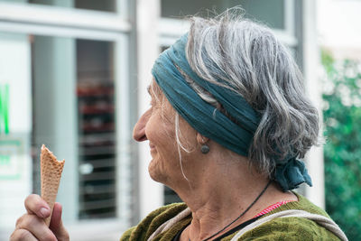 Close-up smiling woman holding ice cream cone