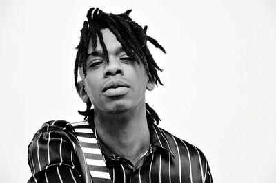Portrait of young man against white background