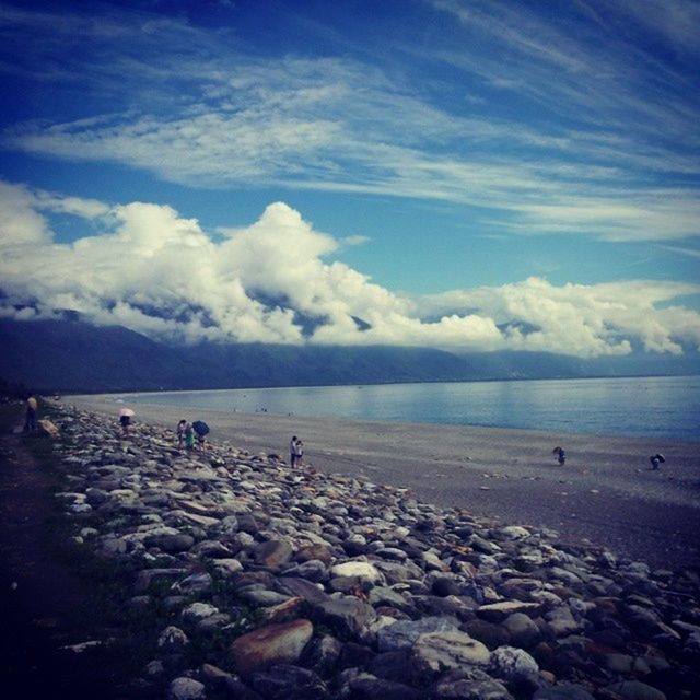 water, sky, sea, scenics, beach, tranquil scene, cloud - sky, beauty in nature, tranquility, shore, nature, mountain, cloud, bird, animal themes, cloudy, idyllic, rock - object, horizon over water, blue