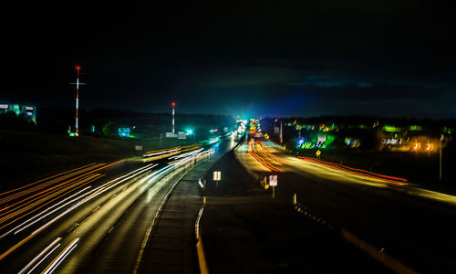 Light trails on road in city at night