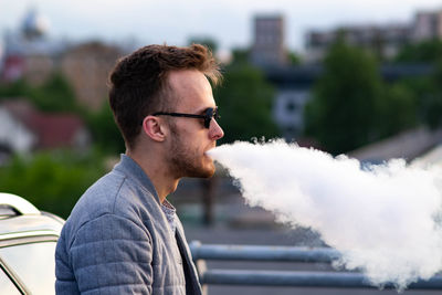 Man exhaling smoke