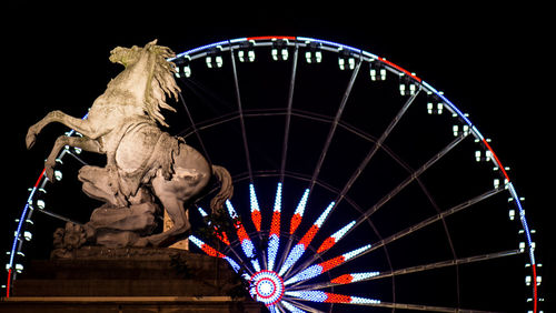 Low angle view of illuminated ferris wheel