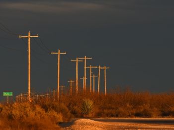 Electricity pylon on landscape against sky