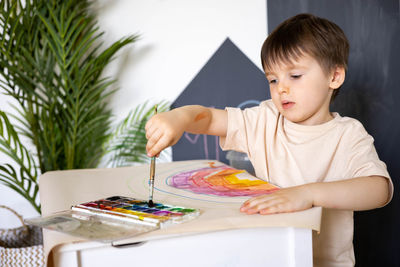 Cute girl painting on table