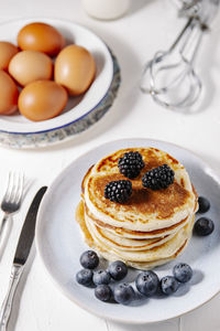 Stack of homemade pancakes bith berries