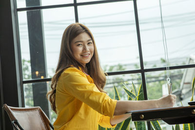 Smiling businesswoman working on table at office