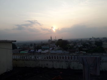 High angle view of buildings against cloudy sky