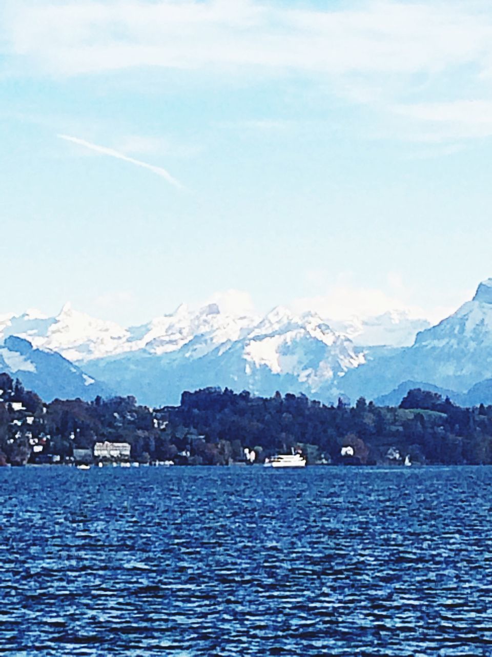 mountain, waterfront, water, mountain range, scenics, tranquil scene, sky, tranquility, beauty in nature, lake, sea, nature, building exterior, built structure, rippled, architecture, river, cloud - sky, cloud, outdoors