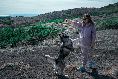 Full length of man standing with dog