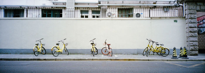 Bicycles on road by building