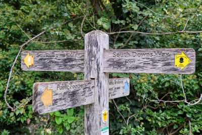 Close-up of sign on wooden fence