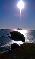 Close-up of sun over sea against sky