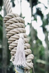 Close-up of rope tied to wooden post