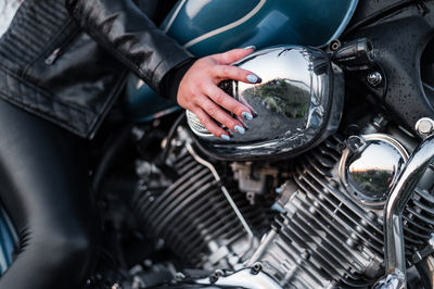 Midsection of woman sitting on motorcycle