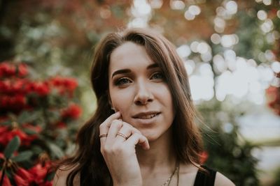 Portrait of smiling woman against trees