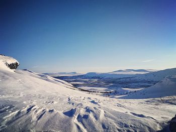 Scenic view of snowcapped mountains against clear sky