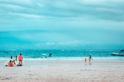 People on beach against sky
