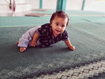 Portrait of cute boy on rug