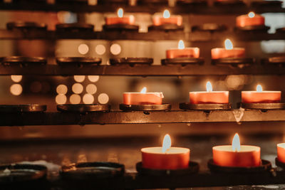 Close-up of lit candles in temple