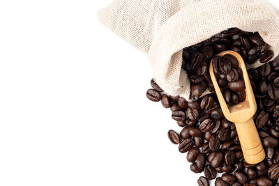 High angle view of coffee beans against white background