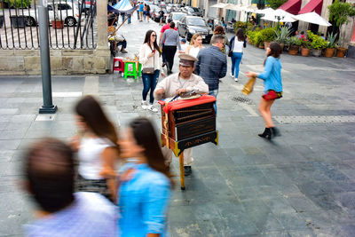 People walking on street in city