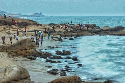 People on beach against sky