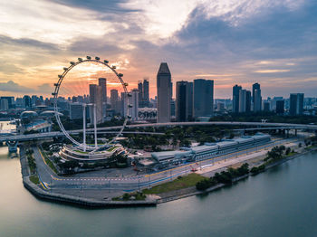 View of cityscape against cloudy sky