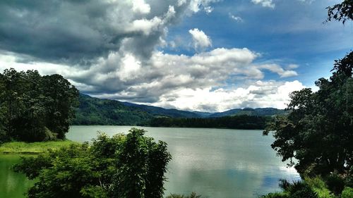 Scenic view of lake against cloudy sky