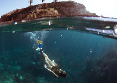 Woman swimming in sea at canary islands