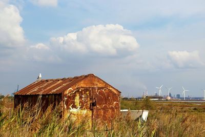 Built structure on field against sky