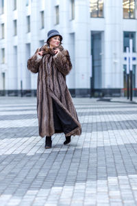 Low section of woman walking on street