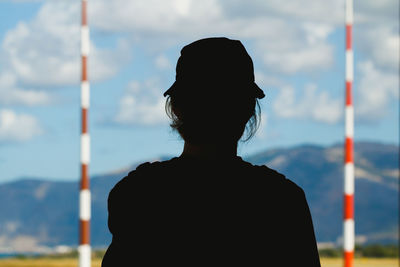 Rear view of man standing against sky