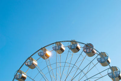 Ferris wheel without people in the clear blue sky. ferris wheel in the park in bright sunlight