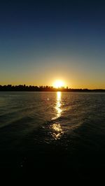 Scenic view of sea against clear sky during sunset