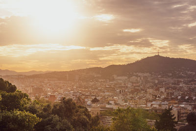 High angle shot of townscape against sky at sunset